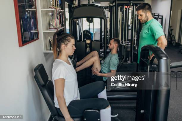 two people exercising with fitness trainer - women's weightlifting stock pictures, royalty-free photos & images