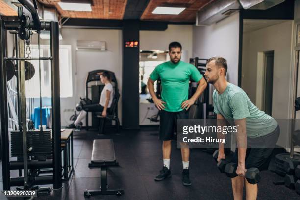 man exercising with fitness trainer - deadlift stock pictures, royalty-free photos & images