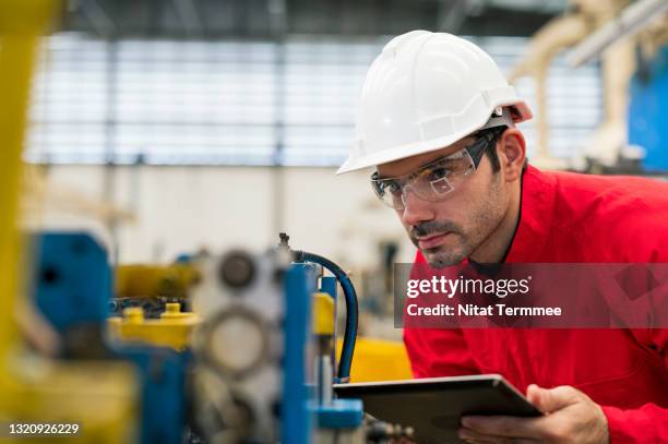 quality control engineer inspecting accuracy of welding jig for auto parts in production line shopfloor. quality control assurance in auto part industry. - auto cad stock pictures, royalty-free photos & images