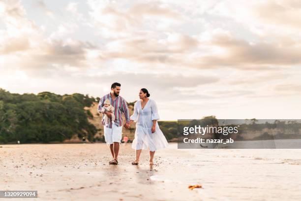 small pacific island family on beach. - pacific ocean stock pictures, royalty-free photos & images
