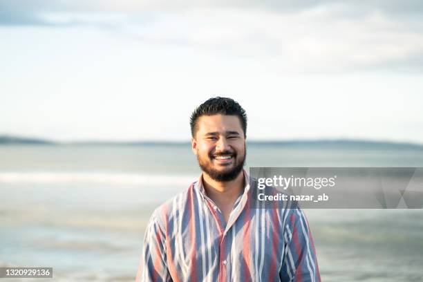 happy man on beach looking at camera. - south pacific islands culture stock pictures, royalty-free photos & images