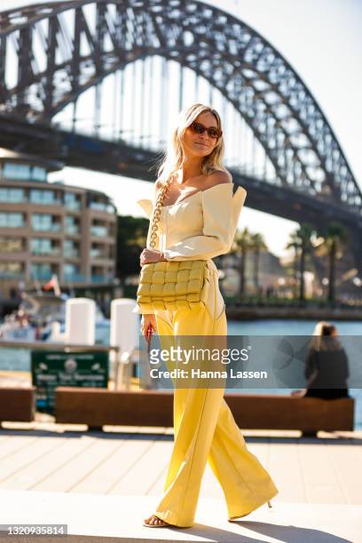 Nadia Fairfax wearing yellow Paris Georgia top and pants, Bottega Veneta bag Banbe sunglasses at Afterpay Australian Fashion Week 2021 on May 31,...