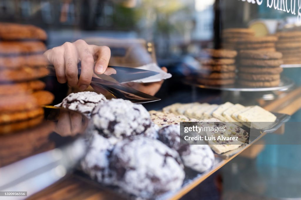 Waiter picking up food from display for serving at a cafe