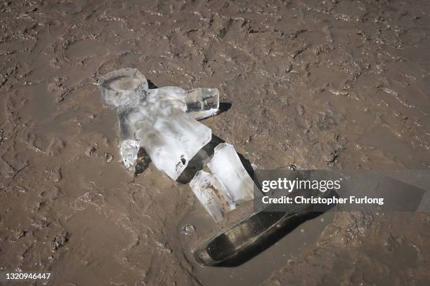 One of 26 ice sculptures of children installed on New Brighton Beach begin to melt, as ice statues of children were installed as part of a giant sand...