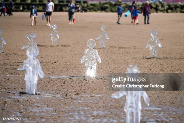 Some of 26 ice sculptures of children installed on New Brighton Beach begin to melt, as ice statues of children were installed as part of a giant...