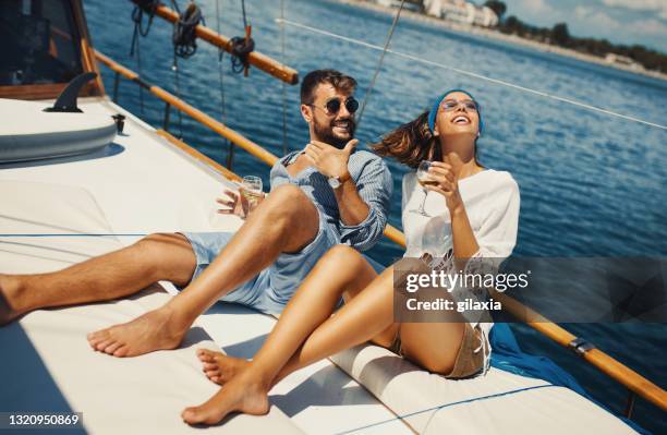 young couple on a sailing cruise. - luxury cruise relaxing stock pictures, royalty-free photos & images