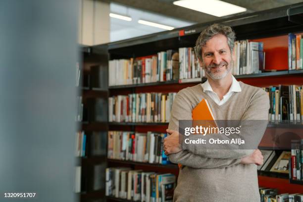 happy man at the library - librarian stock pictures, royalty-free photos & images