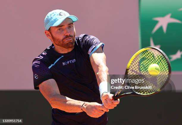 Bjorn Fratangelo of The United States plays a backhand in their mens singles first round match against Cameron Norrie of Great Britain on day two of...