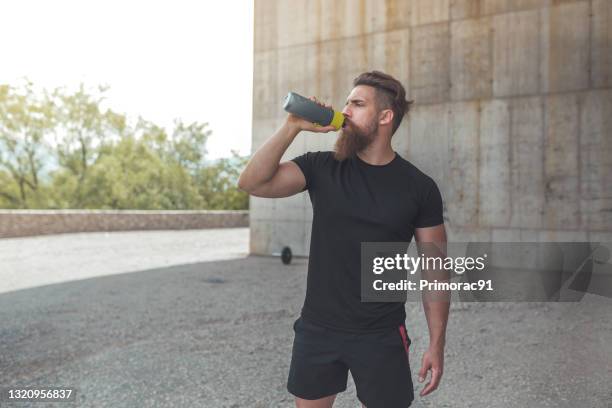 athlete resting after running stock photo - protein drink stock pictures, royalty-free photos & images