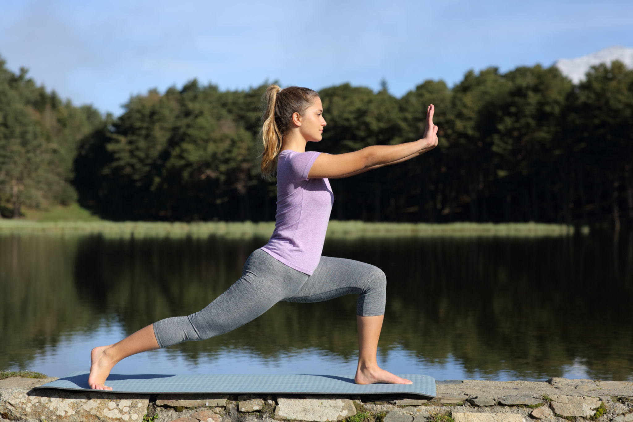 Woman practicing tai chi pose in a lake Woman practicing tai chi pose in a lake