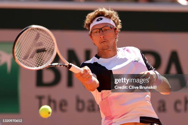 Denis Istomin of Uzbekistan plays a forehand in their ladies singles first round match against Roger Federer of Switzerland on day two of the 2021...
