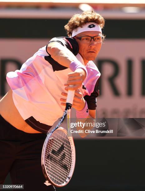 Denis Istomin of Uzbekistan servers in their mens singles first round match against Roger Federer of Switzerland on day two of the 2021 French Open...