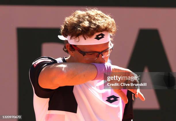 Denis Istomin of Uzbekistan reacts in their mens singles first round match against Roger Federer of Switzerland on day two of the 2021 French Open at...