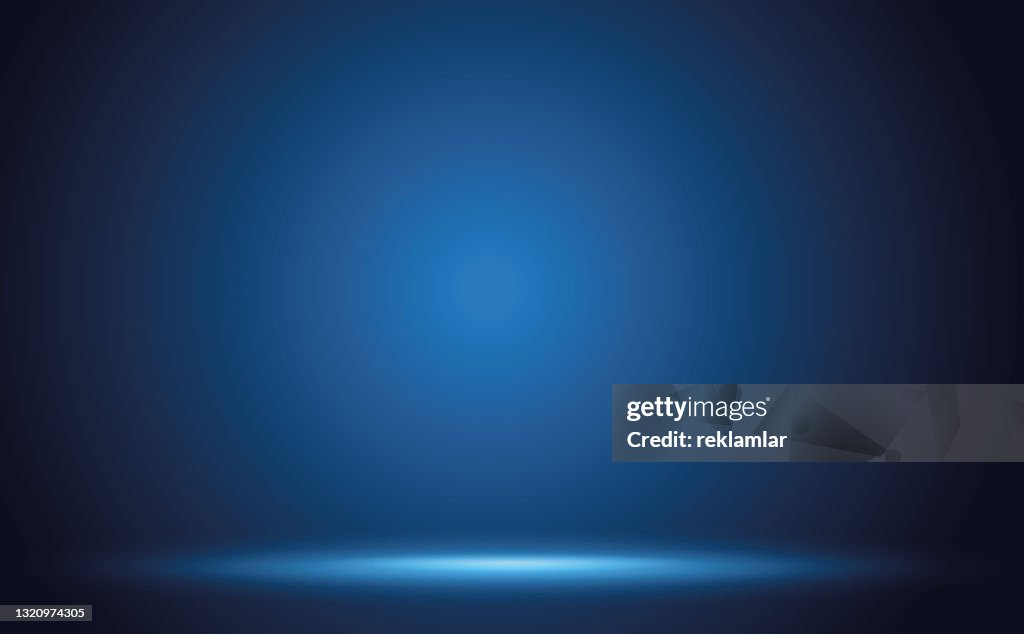Fundo abstrato do estúdio de parede de gradiente azul com iluminação e espaço para o seu texto.