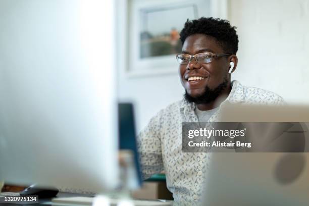 businessman on video call from home office - covid-19 south africa stock pictures, royalty-free photos & images