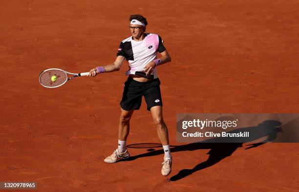 Denis Istomin of Uzbekistan plays a forehand in their ladies singles first round match against Roger Federer of Switzerland on day two of the 2021...