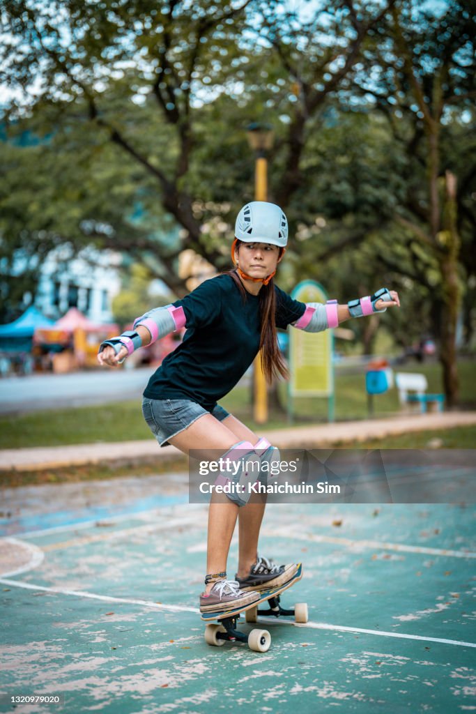 Girl skateboarding in a park
