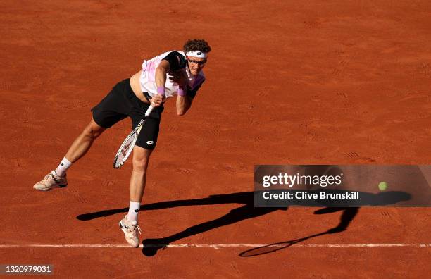 Denis Istomin of Uzbekistan serves in their ladies singles first round match against Roger Federer of Switzerland on day two of the 2021 French Open...