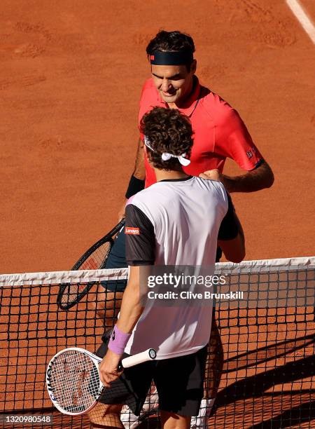 Roger Federer of Switzerland is congratulated on victory by opponent Denis Istomin of Uzbekistan on day two of the 2021 French Open at Roland Garros...