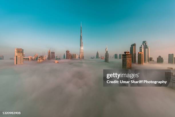 downtown dubai covered in early morning fog - dubai fog stock pictures, royalty-free photos & images