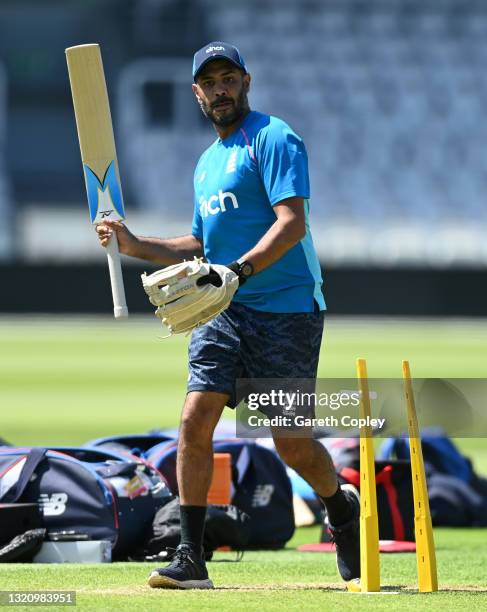 England coach Jeetan Patel hits the ball during a fielding drill during a nets session at Lord's Cricket Ground on May 31, 2021 in London, England.