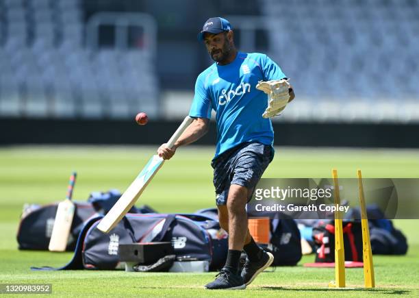 England coach Jeetan Patel hits the ball during a fielding drill during a nets session at Lord's Cricket Ground on May 31, 2021 in London, England.