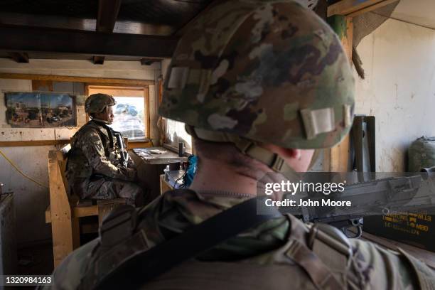 Army soldiers look onto Baghdad from a guardhouse on the perimeter of the International Zone on May 30, 2021 in Baghdad, Iraq. Coalition forces based...