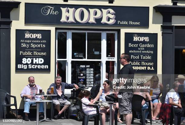 People sit and enjoy a pint outside the Hope pub on the seafront on May 31, 2021 in Southend, England. Today's bank holiday Monday brings highs of...