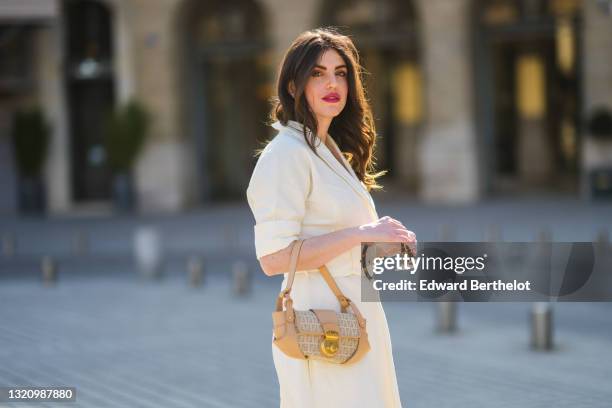 Sara Carnicella @lafillerebelle wears white vintage sunglasses, gold and silver earrings, gold chain necklaces, a white V-neck Natan belted long...