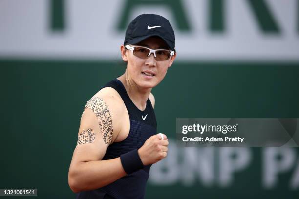 Zheng Saisai of China celebrates in their ladies singles first round match against Sara Sorribes Tormo of Spain on day two of the 2021 French Open at...