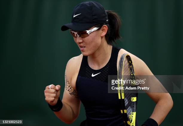 Zheng Saisai of China celebrates in their ladies singles first round match against Sara Sorribes Tormo of Spain on day two of the 2021 French Open at...