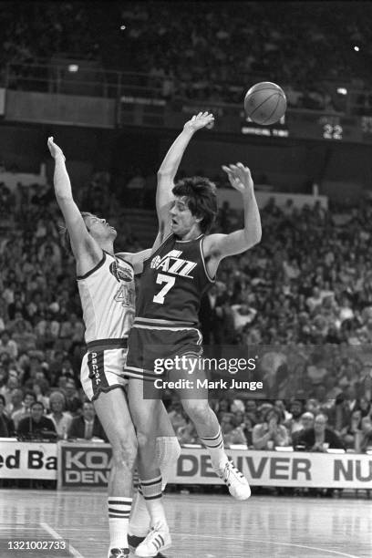 New Orleans Jazz guard Pete Maravich collides with Denver Nuggets center Byron Beck at the free throw line during an NBA basketball game at McNichols...