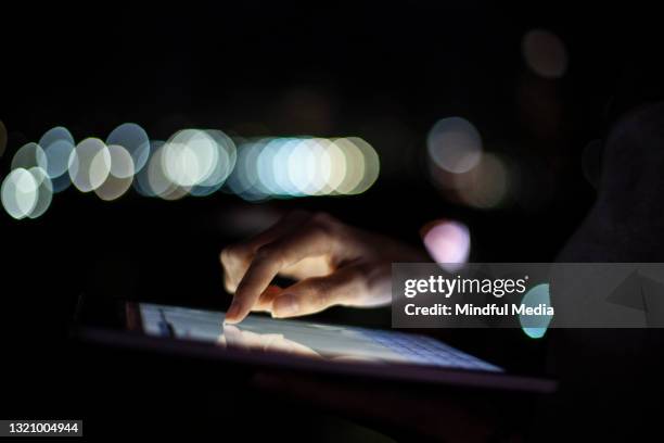 close up of woman´s hand using touchscreen device at night - deep web 個照片及圖片檔