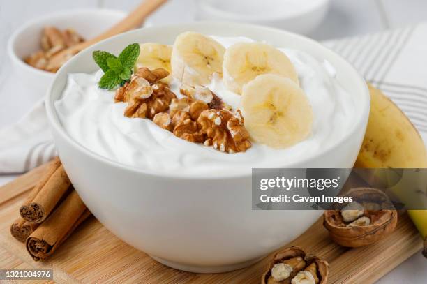 yogurt breakfast with banana and walnuts - curd cheese stock pictures, royalty-free photos & images