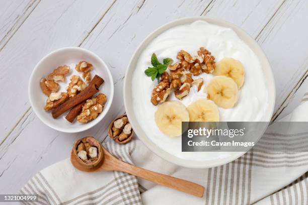 yogurt breakfast with banana and walnuts - iogurte imagens e fotografias de stock