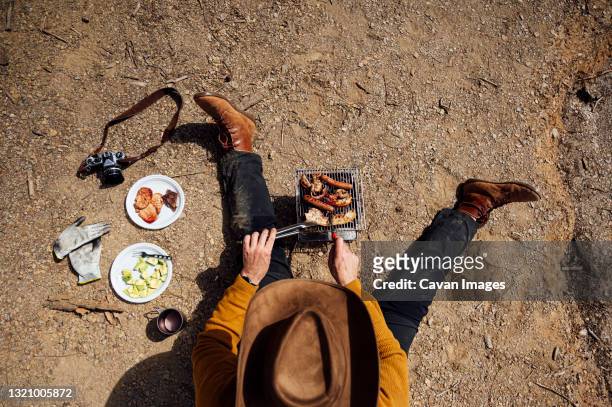 young man doing a barbecue in the field.madrid.spain - bbq avocado imagens e fotografias de stock