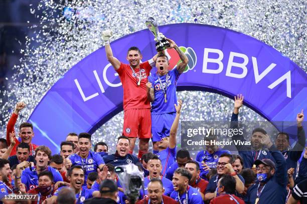 Jesus Corona of Cruz Azul and Julio Cesar Dominguez of Cruz Azul lift the champion's trophy at the end of the Final second leg match between Cruz...