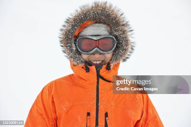portrait of woman with faux fur hood and ski goggles - fake fur stock pictures, royalty-free photos & images