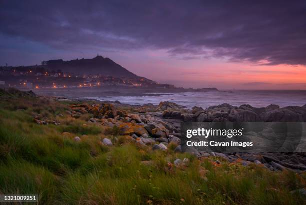 a guarda beautiful sea landscape rock beach with city on foreground - guarda sol stock-fotos und bilder