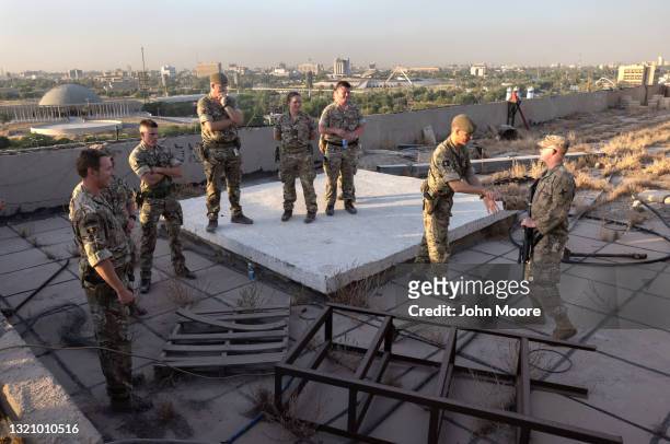British soldiers thank an American soldier for guiding them to a rooftop view in the International Zone on May 29, 2021 in Baghdad, Iraq. Coalition...