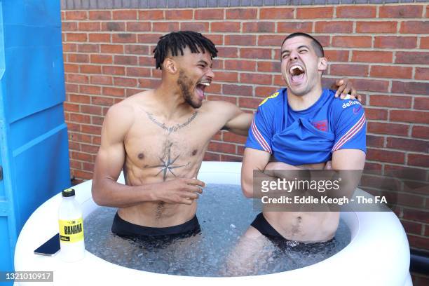 Tyrone Mings and Conor Coady of England share a laugh in an ice bath during a training session at an England Pre-Euro 2020 Training Camp on May 31,...