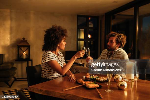 giving a toast to our anniversary - couple dinner date stock pictures, royalty-free photos & images