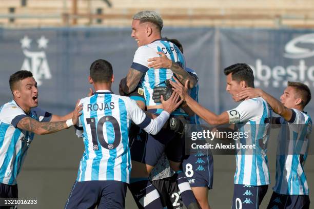 Enzo Copetti of Racing Club celebrates with teammates after scoring the last penalty of the penalty shoot-out for his team to win the semifinal match...