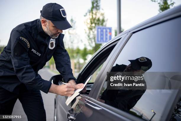 middle aged caucasian male police officer at work - police respect stock pictures, royalty-free photos & images