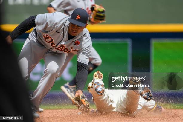 Jonathan Schoop of the Detroit Tigers tags out Christian Yelich of the Milwaukee Brewers trying to steal second base in the fourth inning at American...