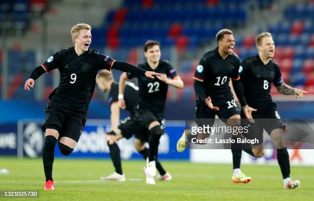 Jonathan Burkardt of Germany celebrates their side's victory following a penalty shoot out after the 2021 UEFA European Under-21 Championship...