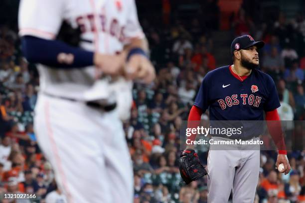 Eduardo Rodriguez of the Boston Red Sox watches the replay after walking Carlos Correa of the Houston Astros during the fifth inning at Minute Maid...