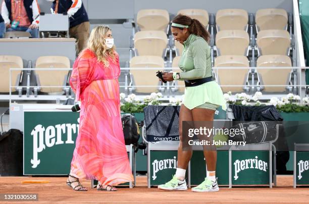 Serena Williams of USA is interviewed on-court by 2013 Wimbledon champion Marion Bartoli of France following her first round victory during day 2 of...