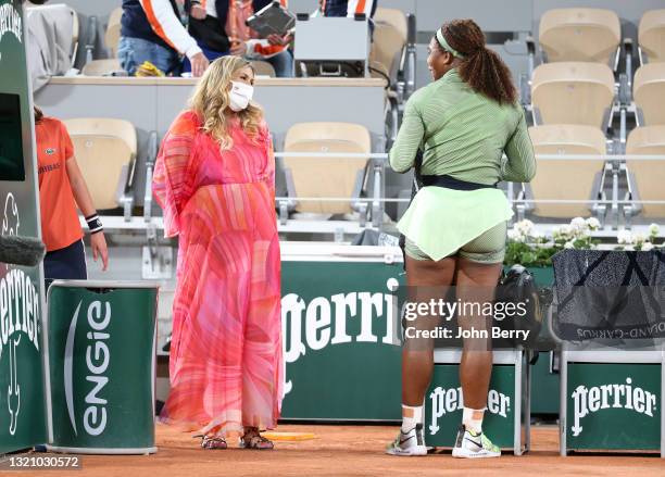 Serena Williams of USA is interviewed on-court by 2013 Wimbledon champion Marion Bartoli of France following her first round victory during day 2 of...