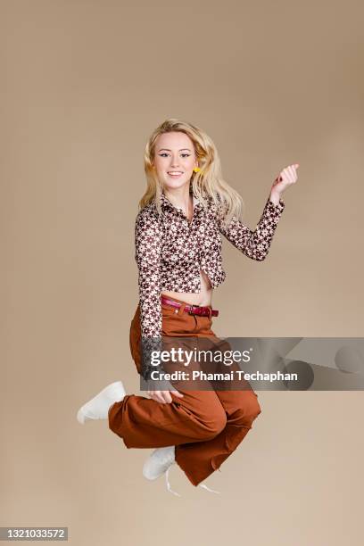 happy young woman in retro style outfit - air guitar stock pictures, royalty-free photos & images
